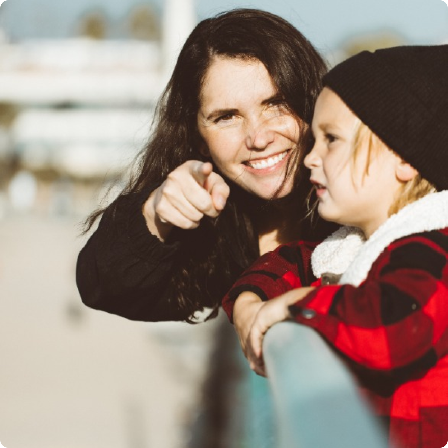 A parent and child smiling together